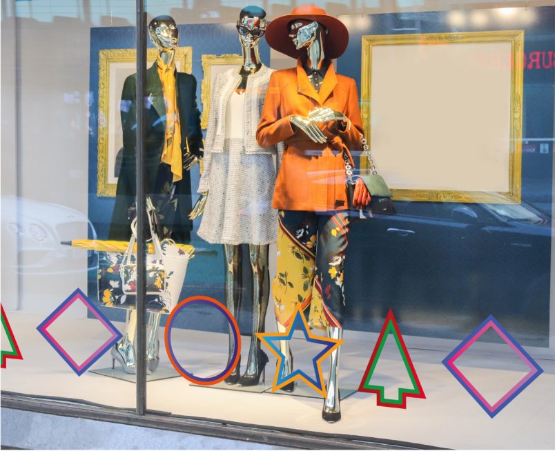 Christmas window decals 2021 - corner cluster option mockup showing colourful star, tree, circle and diamond shapes running across the bottom of a shop window.