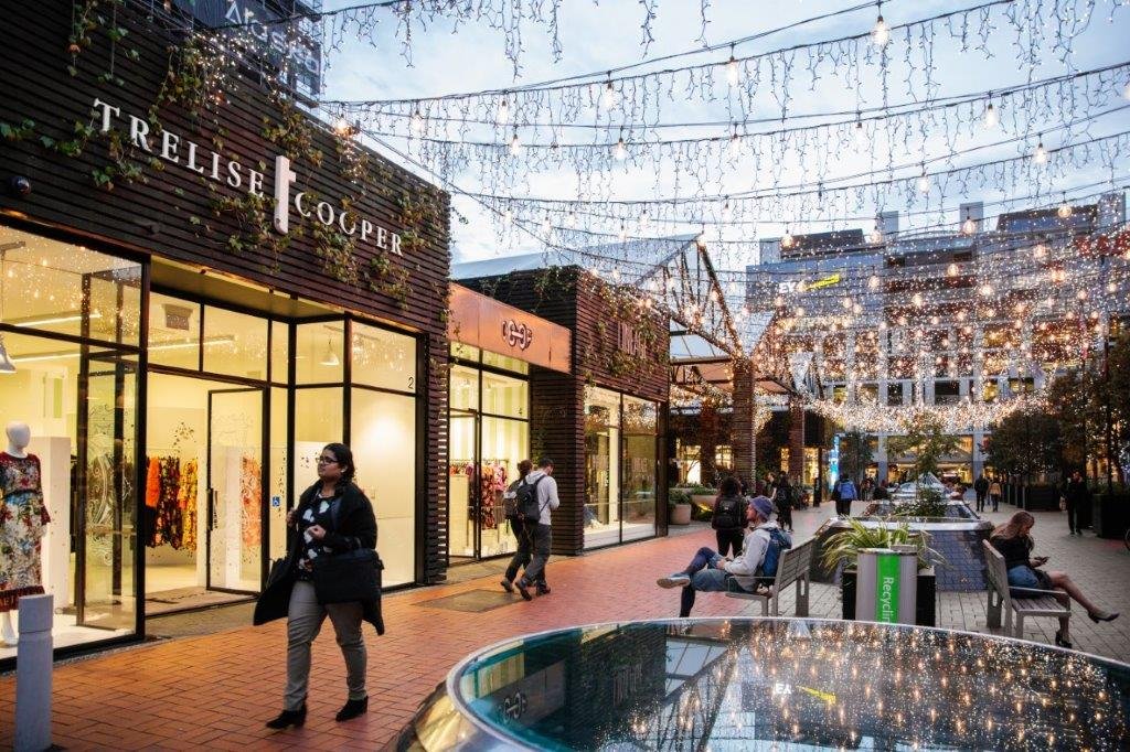 People shopping and spending time in Britomart in Auckland's city centre, with fairy lights, Trelise Cooper, Coop and Lineage. Image: Sacha Stejko.