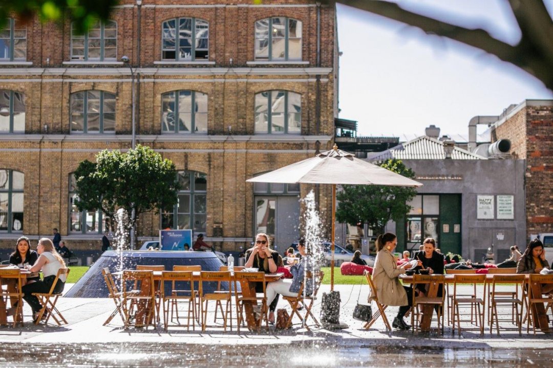 People enjoying lunch in Takutai Square, Britomart in Auckland's city centre. Image: Sacha Stejko.